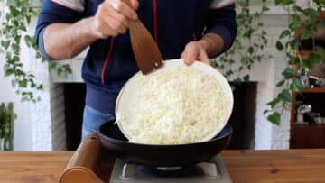 adding grated cauliflower to pan