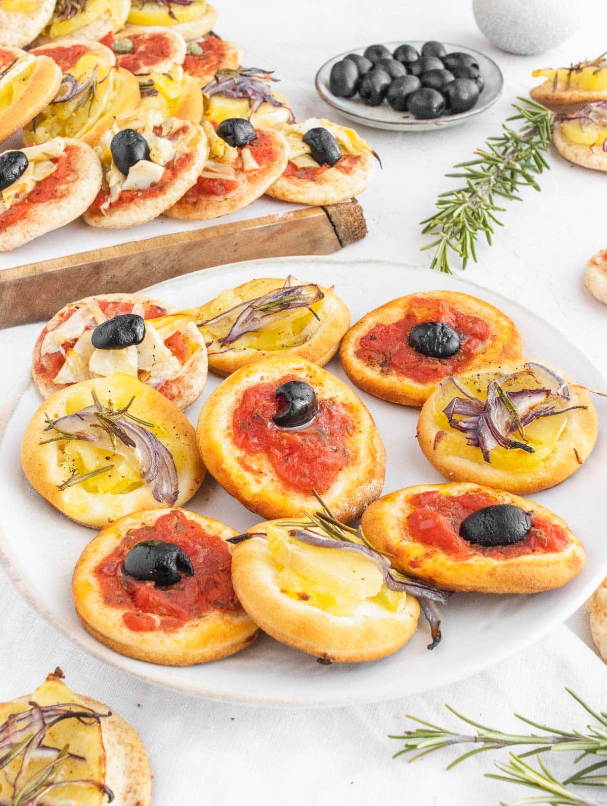 mini pizzas with veggie toppings on a plate