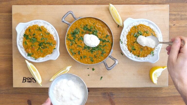 serving the red lentil curry with basmati rice