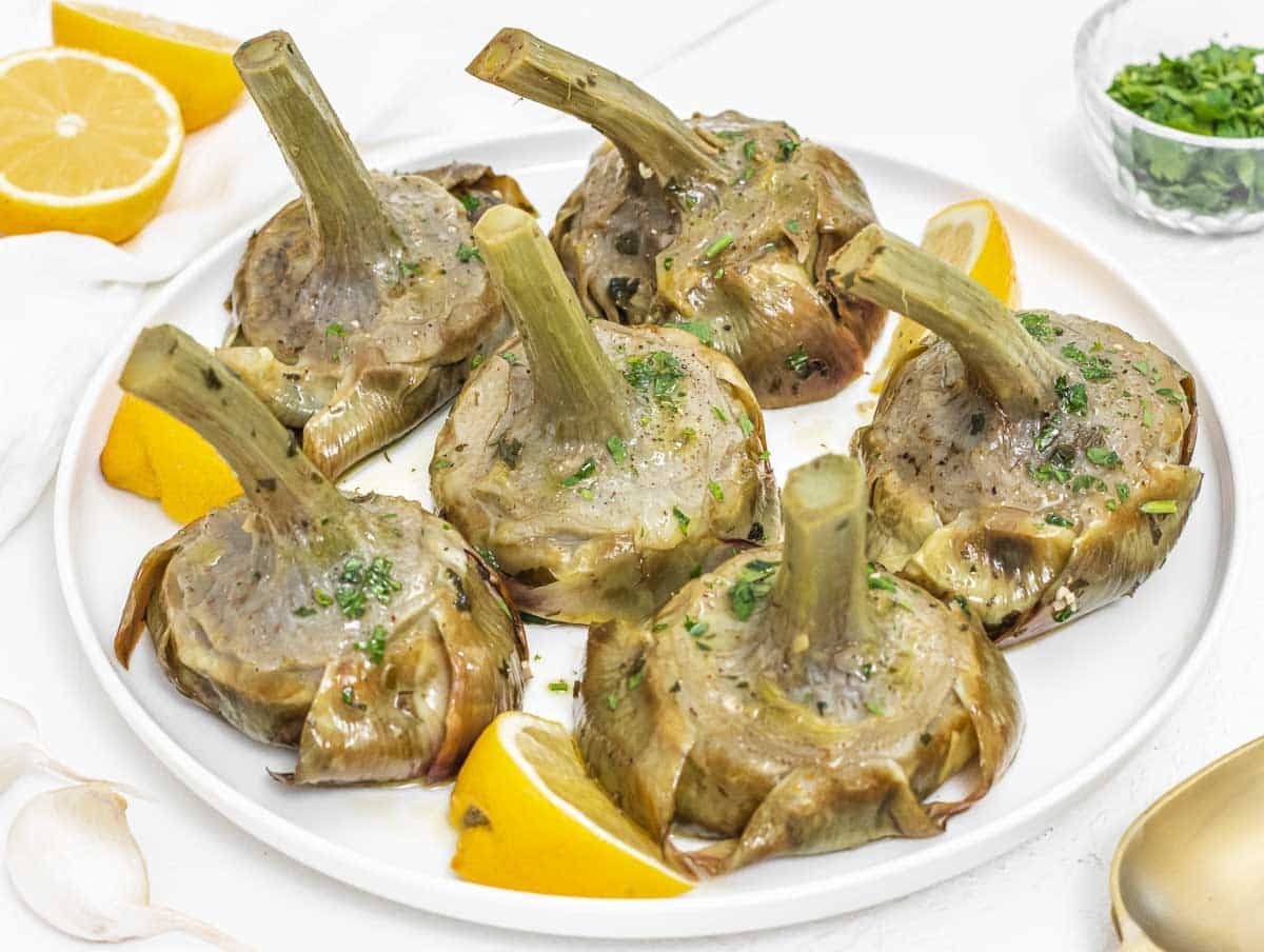 Braised artichokes on a white plate