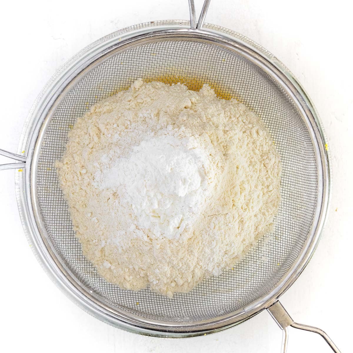 sifting flour and baking powder in the bowl