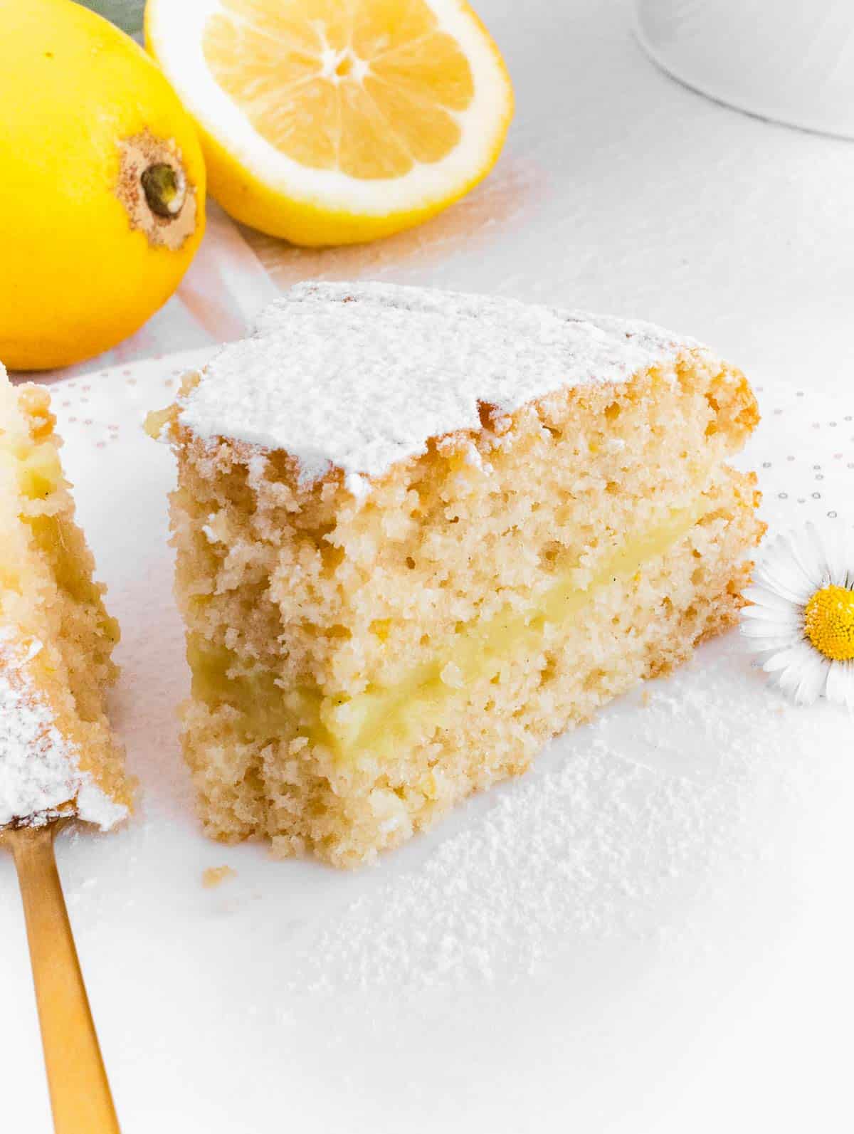 slice of vegan lemon cake with custard filling
