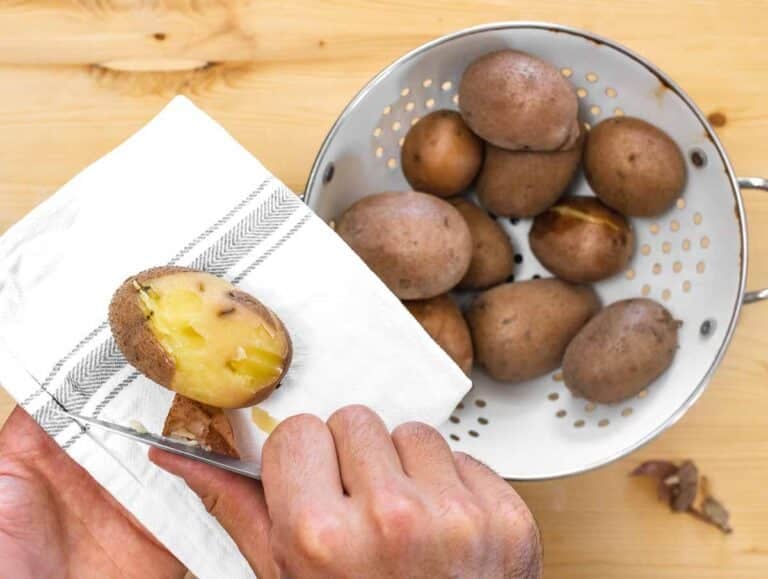 peeling boiled potatoes