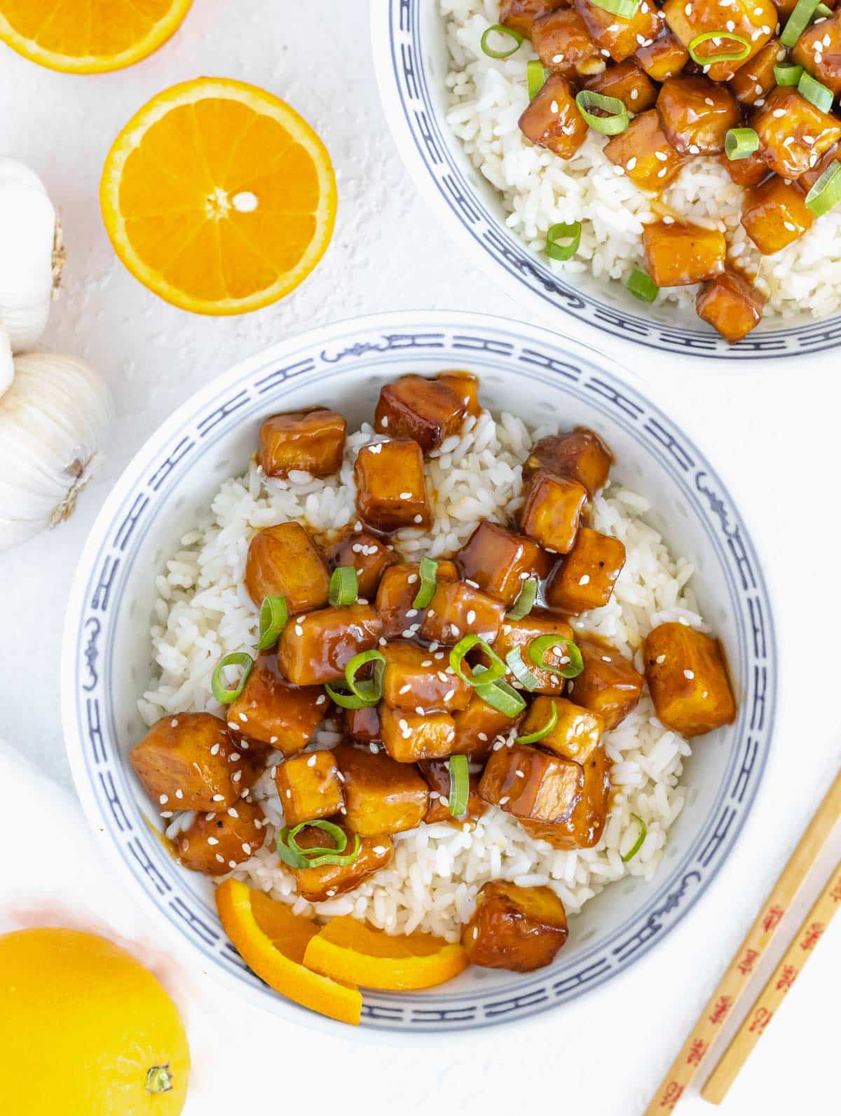 vegan orange tofu on the table with chopstick and rice
