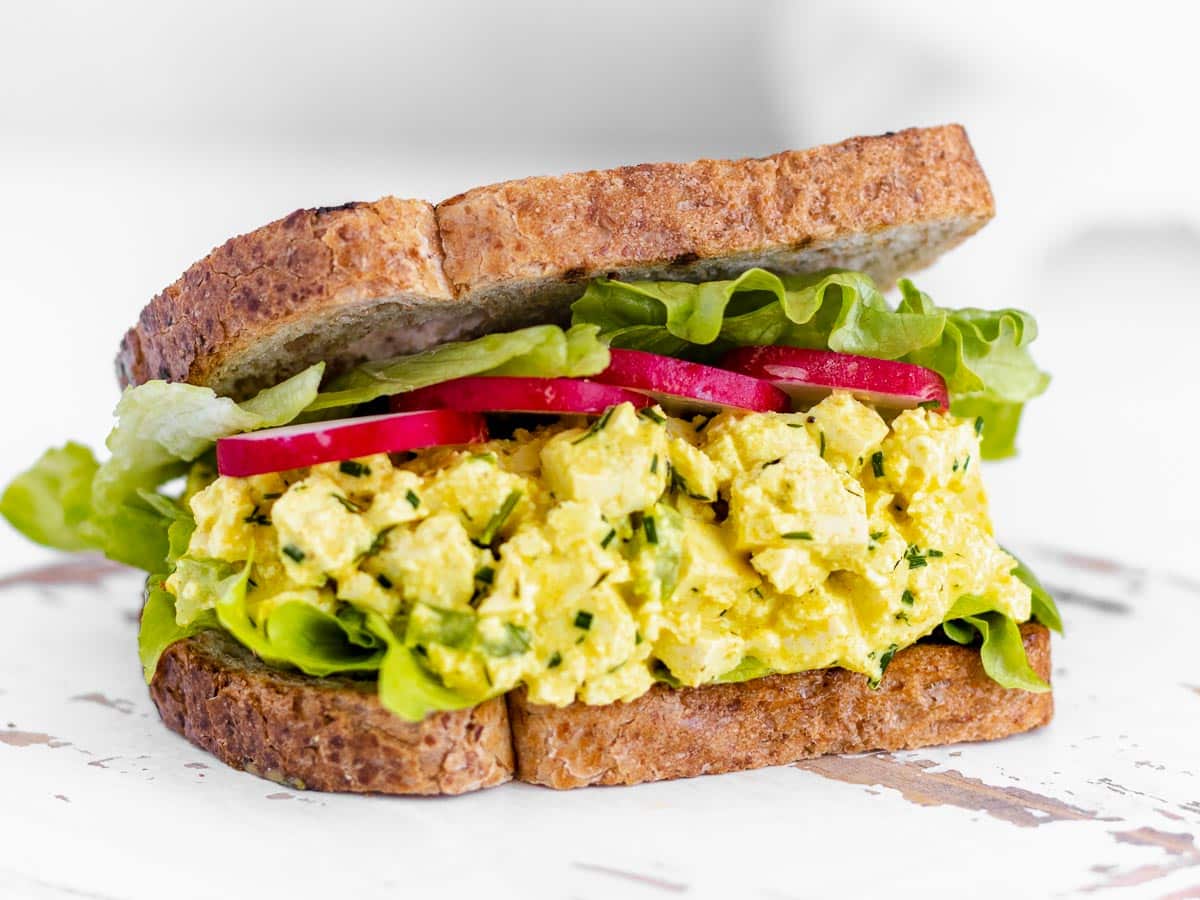 vegan egg salad sandwich with lettuce and radishes