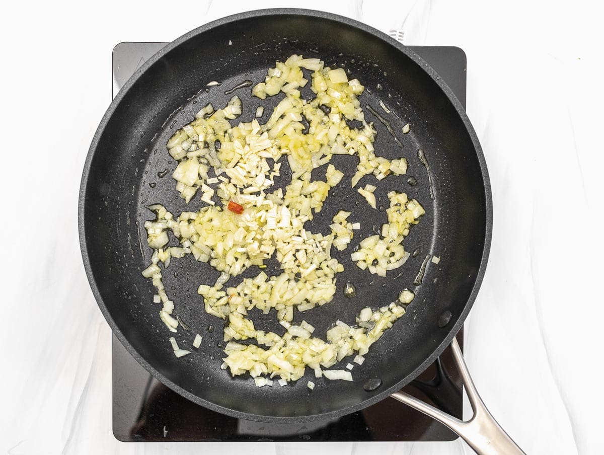 frying the onion in a pan with oil
