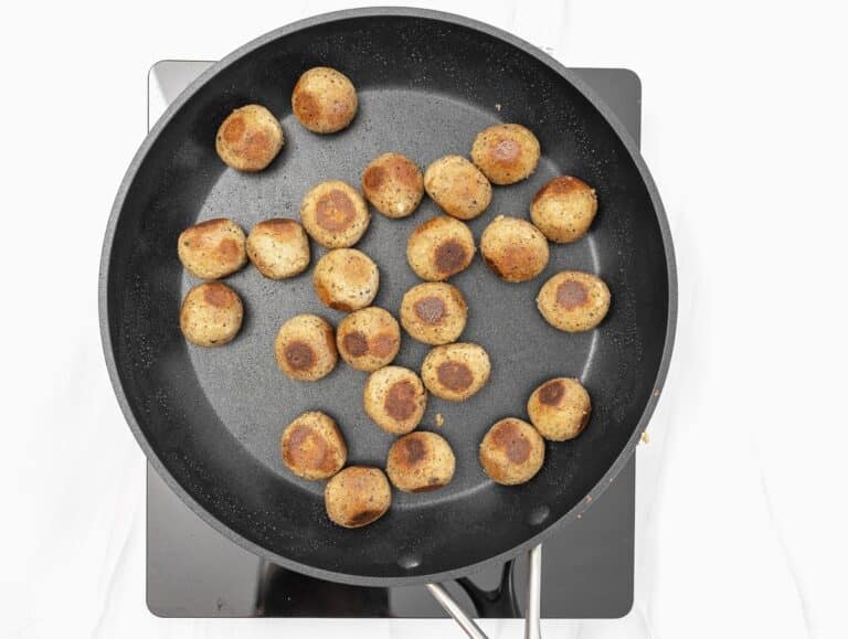 pan-frying the meatballs in a large non-stick skillet