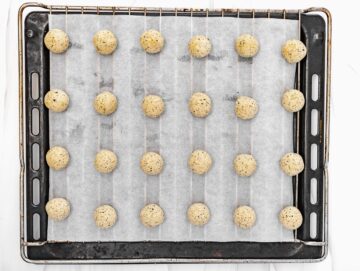vegan meatballs on a baking rack lined with parchment paper
