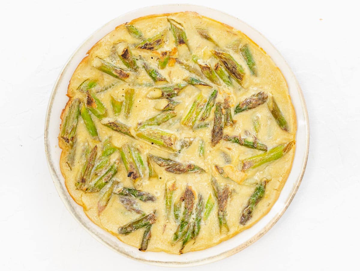 asparagus frittata on a plate, just cooked
