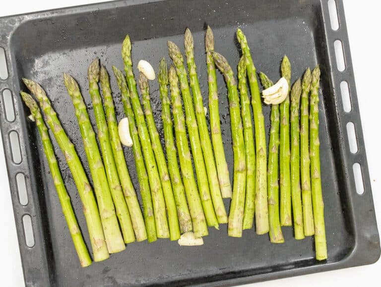 asparagus arranged on a baking sheet