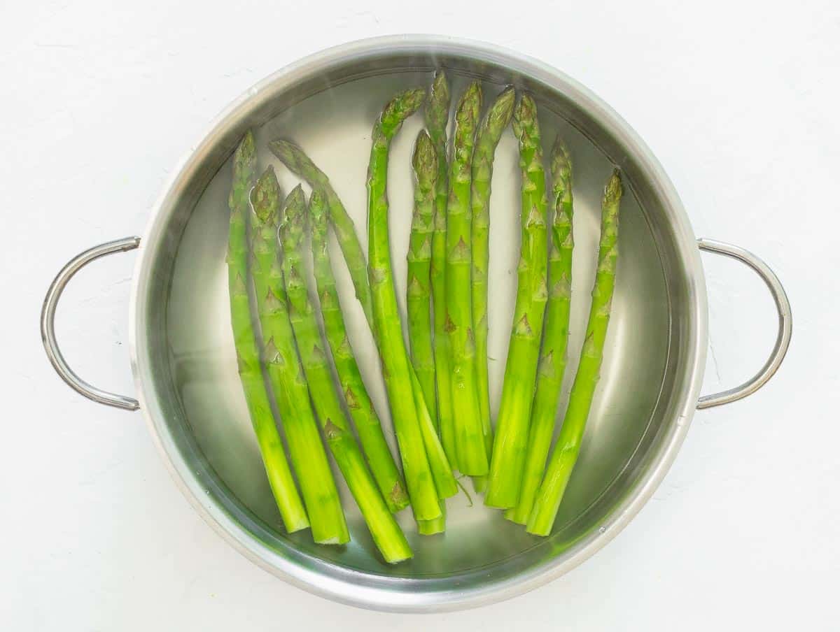 boiling asparagus in a large pan