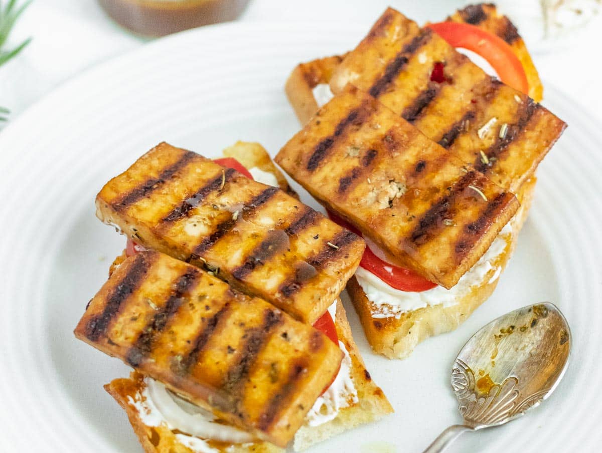 grilled marinated tofu on an open sandwich