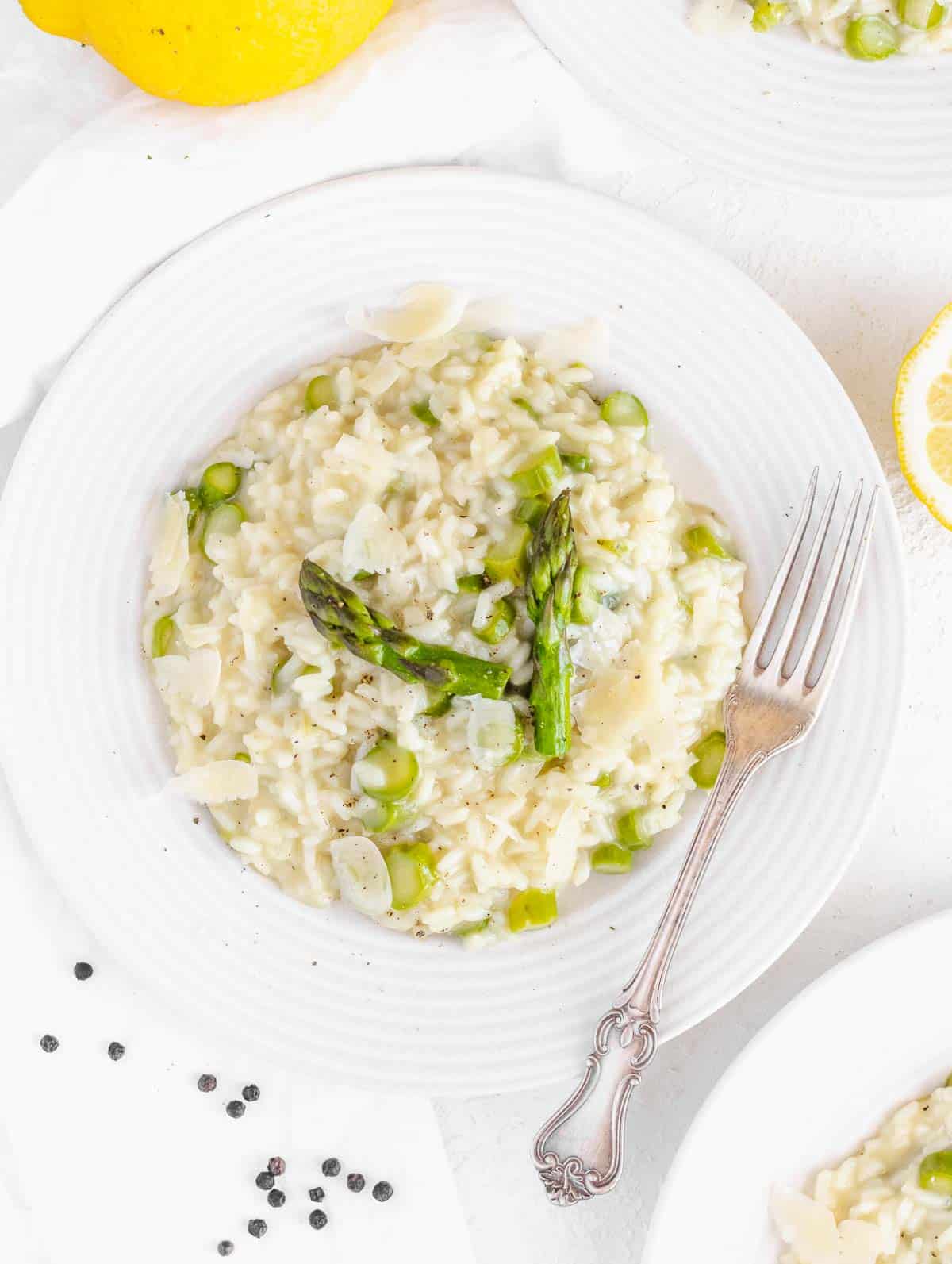 asparagus risotto served with a fork on a flat plate