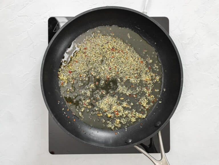 frying garlic and red pepper flakes in oil