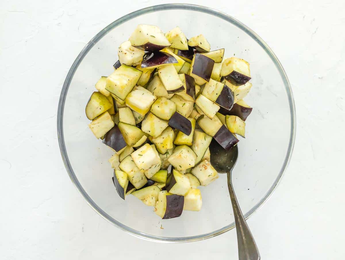 tossing eggplant dice with condiment
