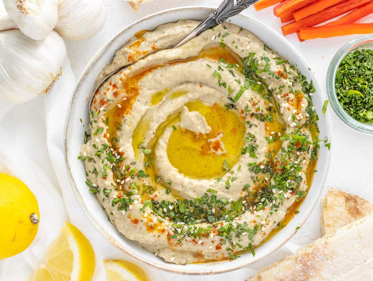 baba ganoush topped with fresh parsley, mint, and olive oil