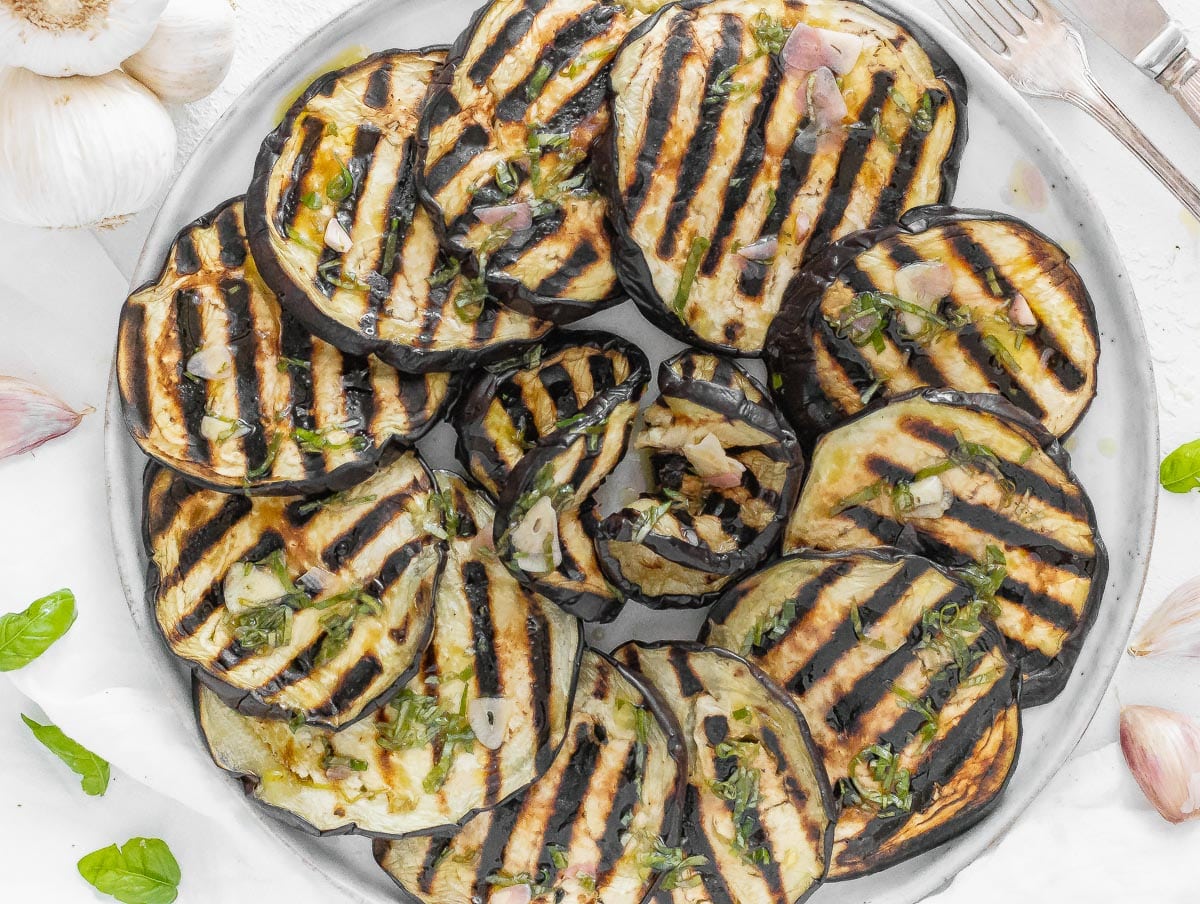 grilled eggplant with basil on a platter