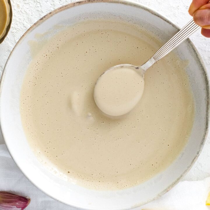 tahini sauce with a spoon
