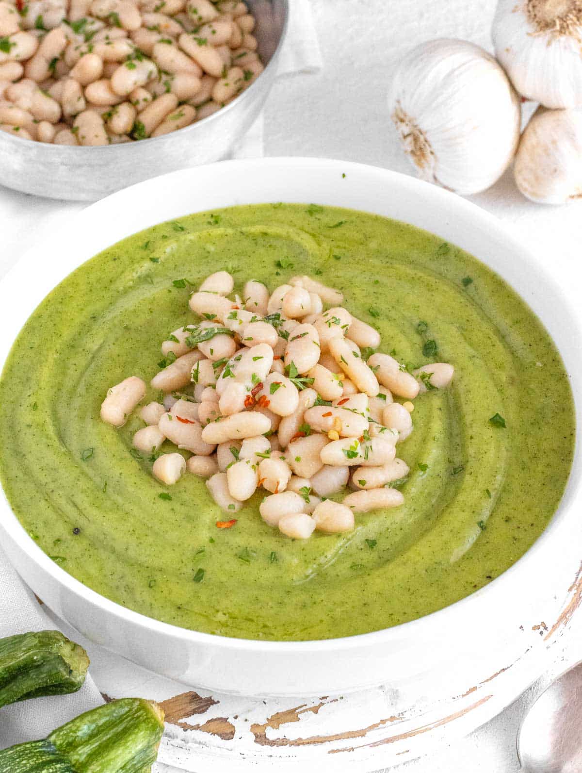 zucchini soup with cannellini beans on top