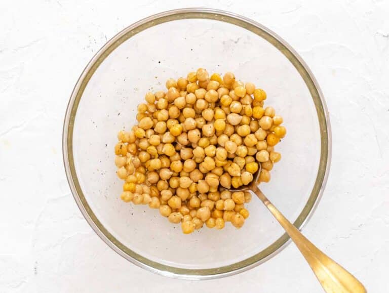 seasoning the chickpeas with olive oil, salt, and pepper