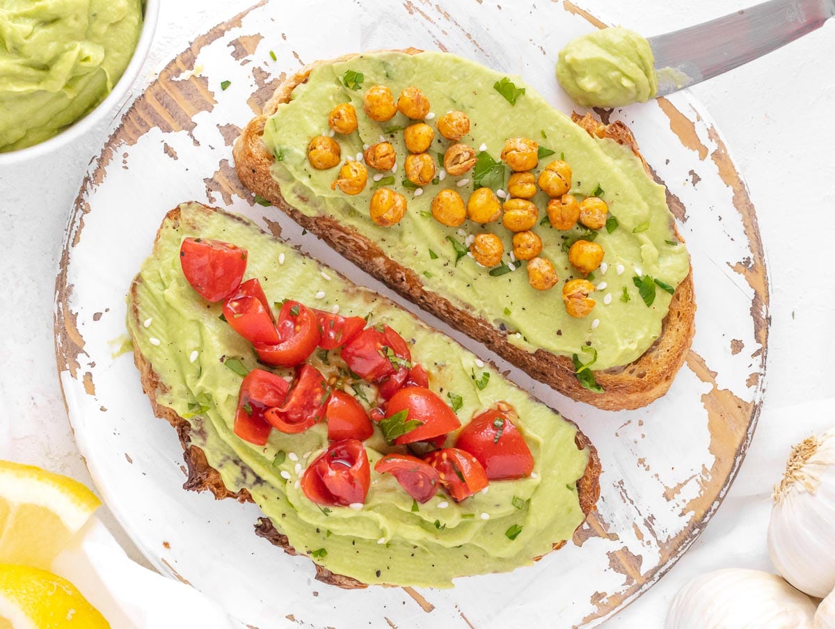 avocado spread on toast with roasted chickpeas and cherry tomatoes