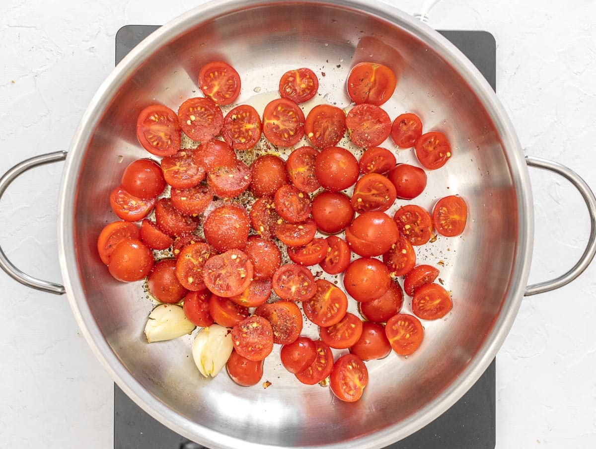 sautéeing tomatoes in a pan