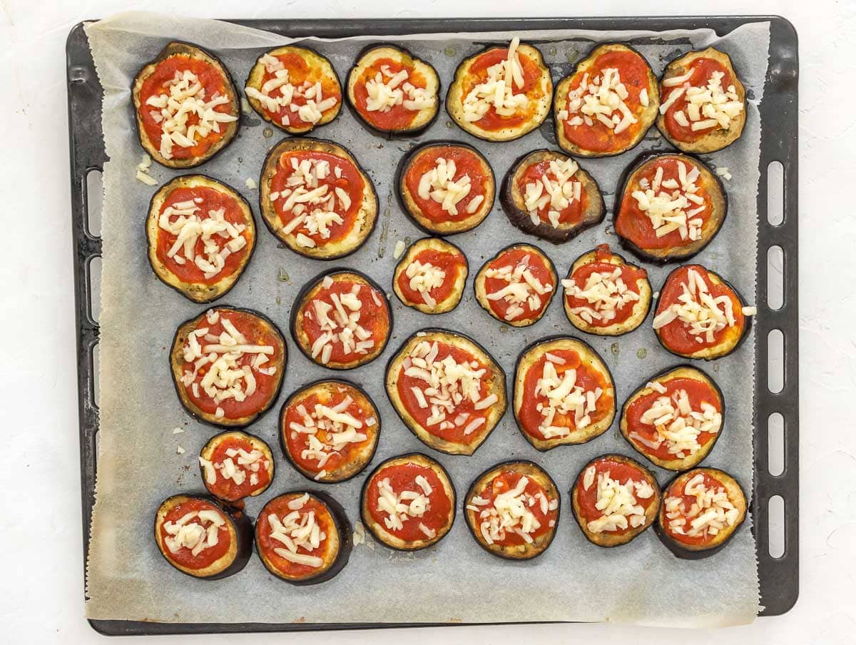 tomato sauce and cheese on top of slices
