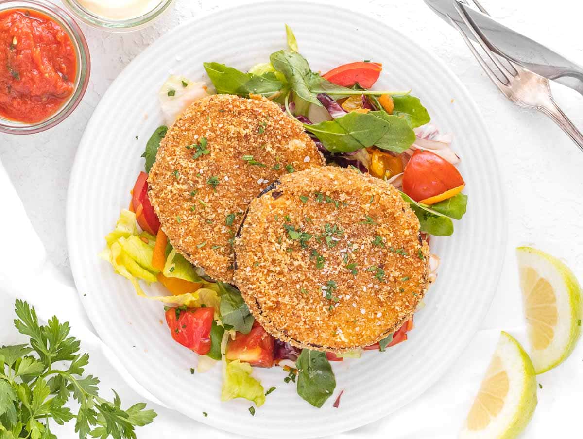 Fried eggplant served on a simple side salad