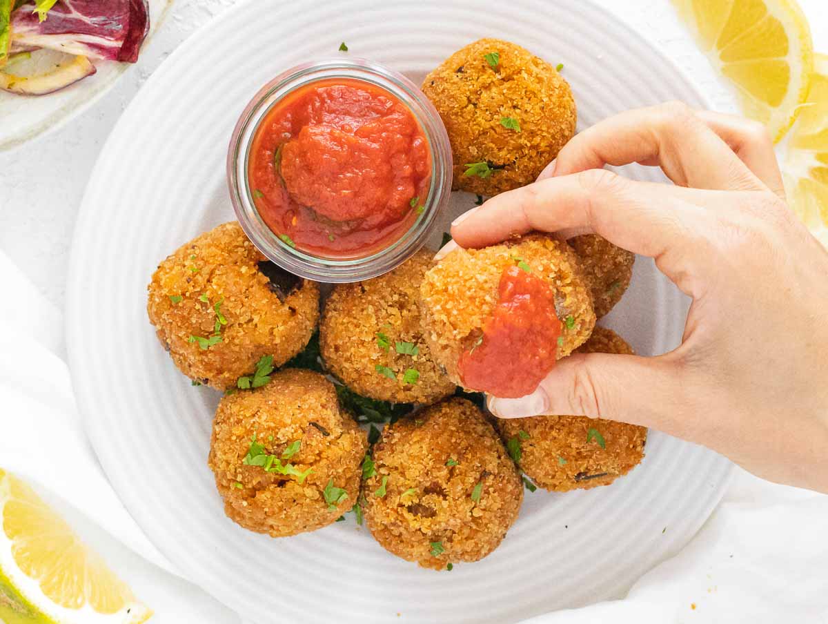 Italian rice balls dipped in marinara sauce