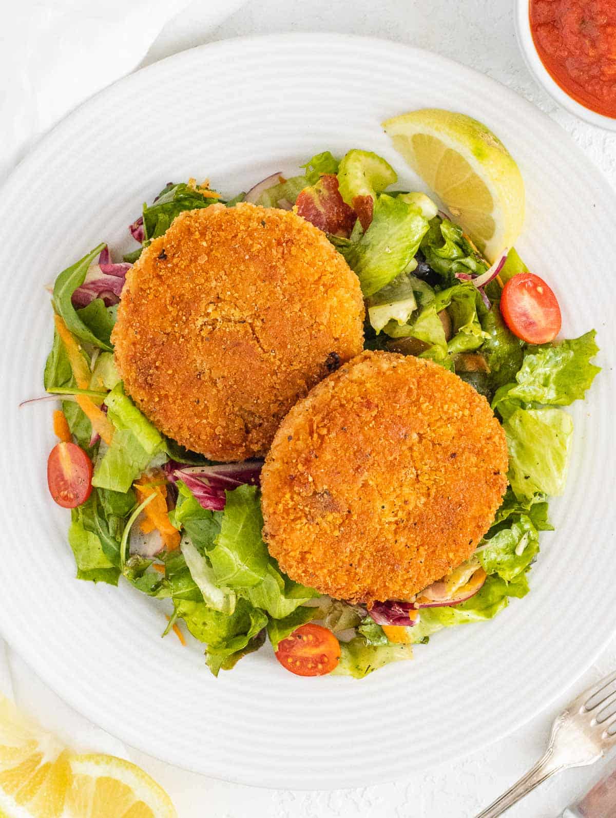 risotto cakes served on a side salad