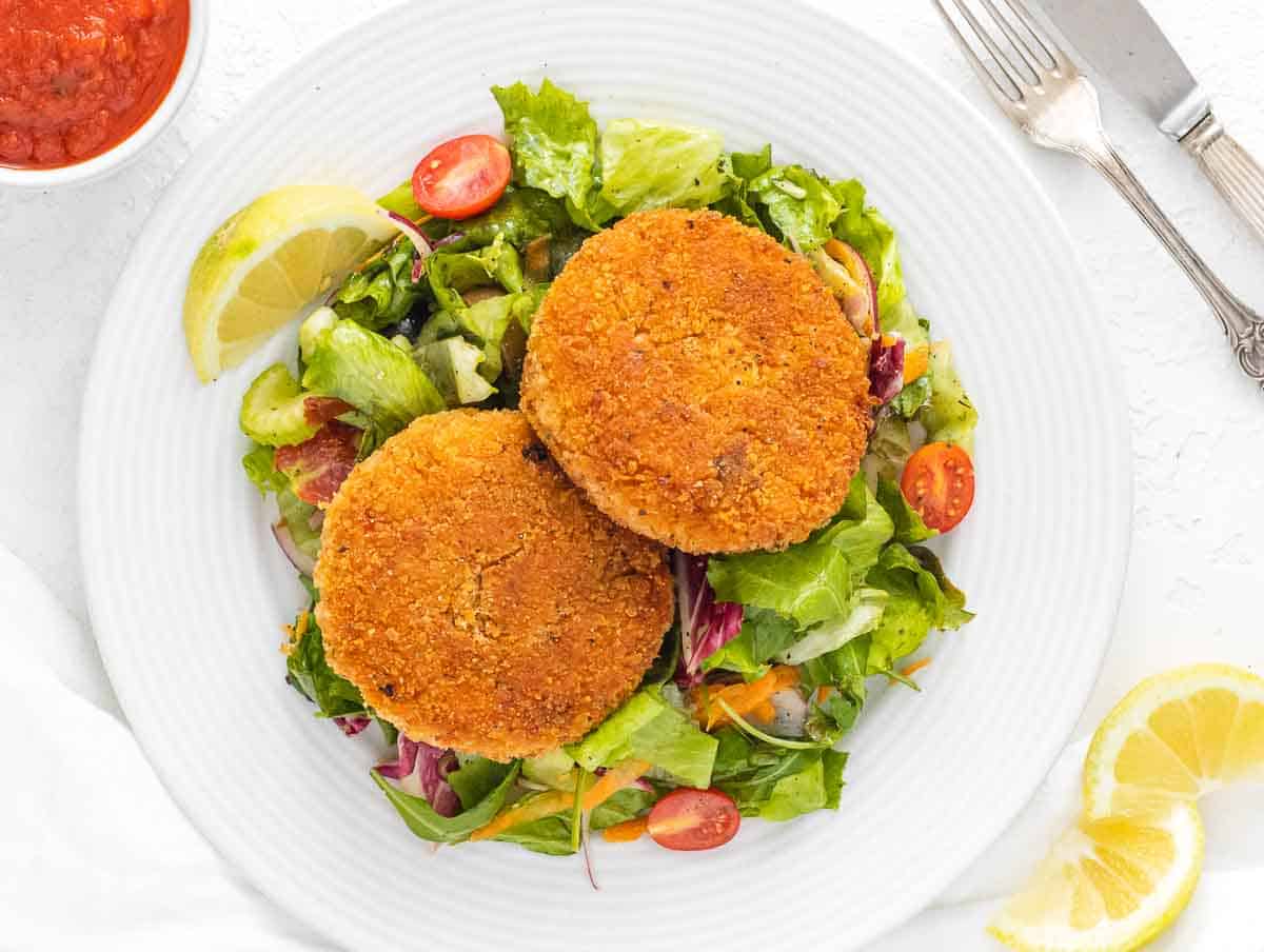 risotto cakes on side salad served with marinara sauce