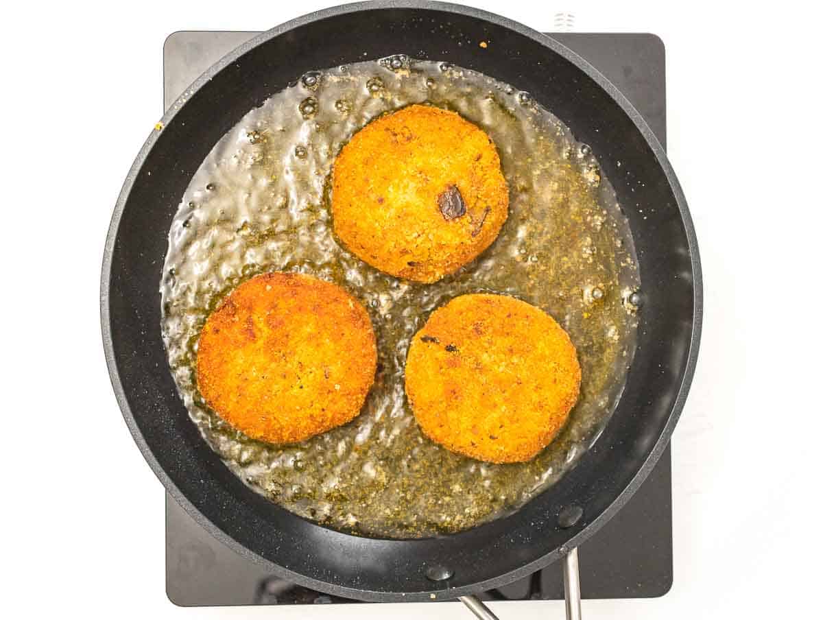 tomato and eggplant risotto cakes shallow frying in a pan