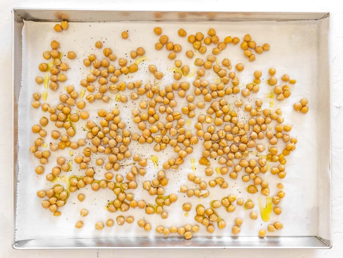 seasoning the chickpeas with oil, salt and pepper