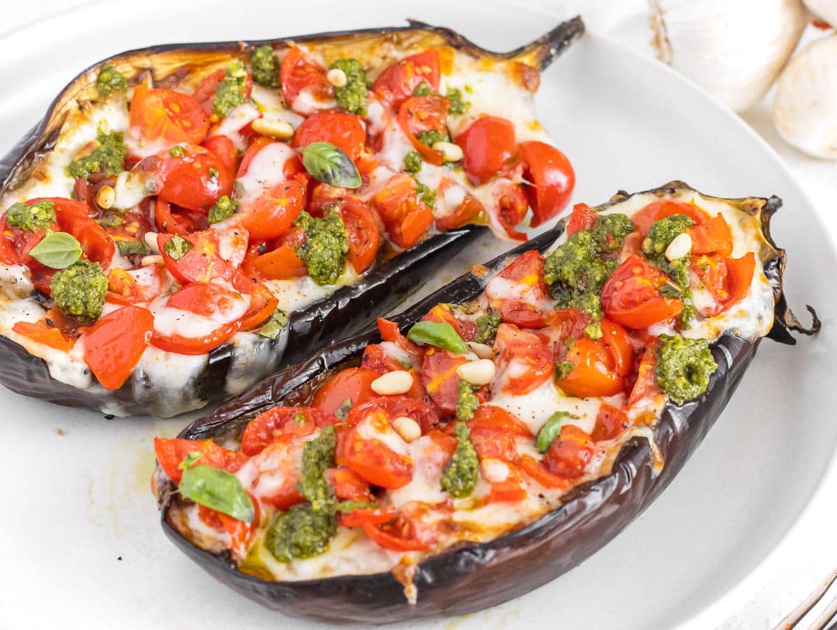 stuffed eggplants with mozzarella, cherry tomatoes, and pesto