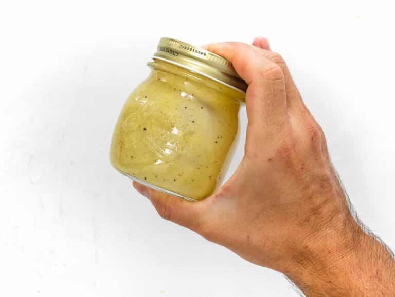 shaking the dressing in a jar