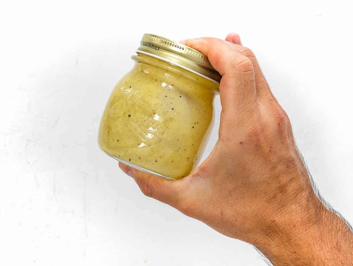 shaking the dressing in a jar