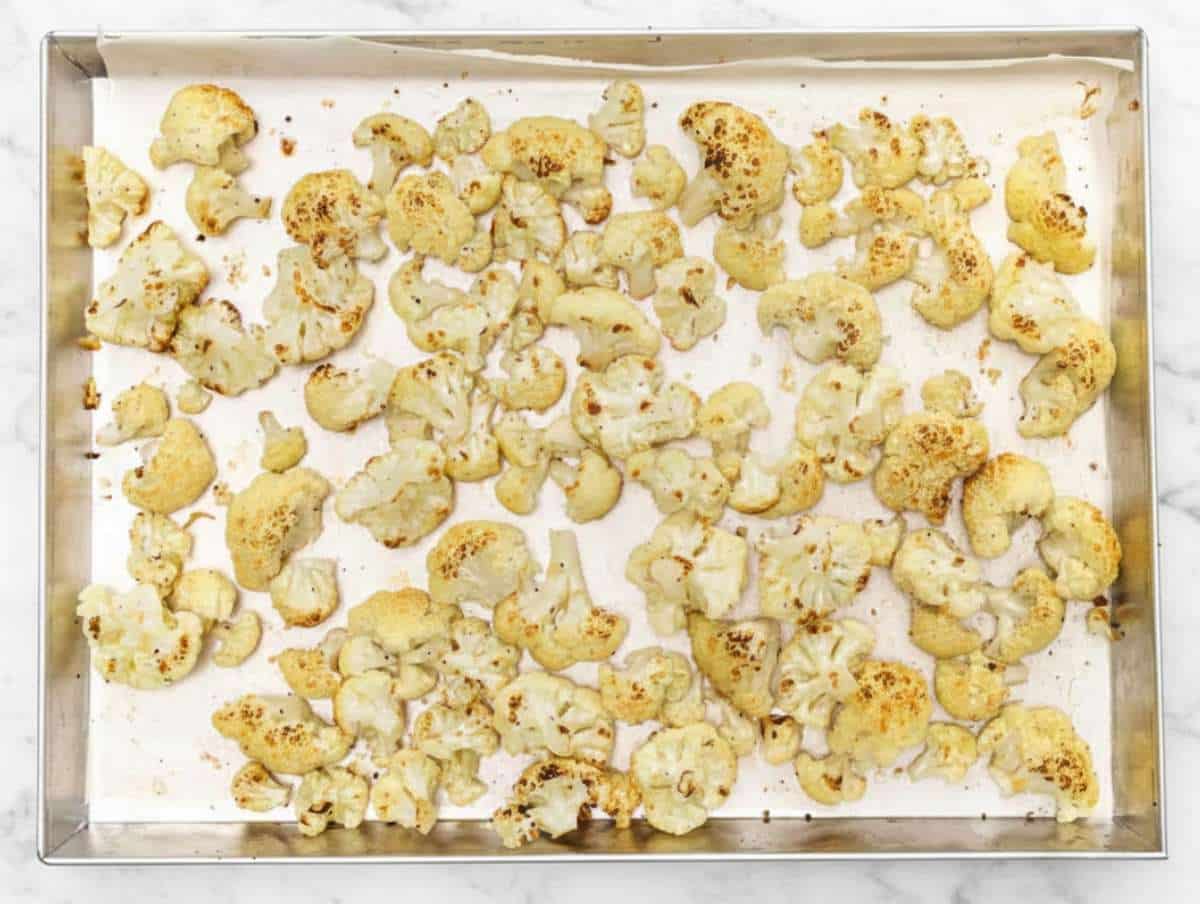 Step 1 Roasting cauliflower florets on baking sheet until golden and lightly charred.