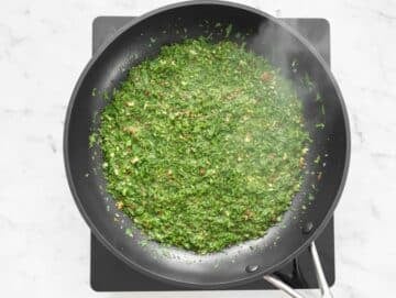 Step 2 Gently sautéing garlic chili flakes parsley and nuts in olive oil.