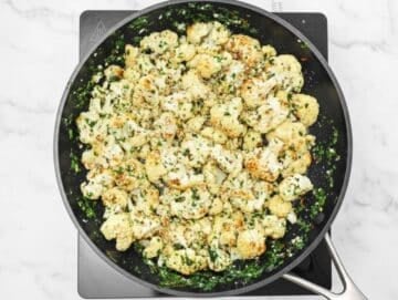 Step 3 Adding roasted cauliflower to garlic olive oil sauce in skillet.
