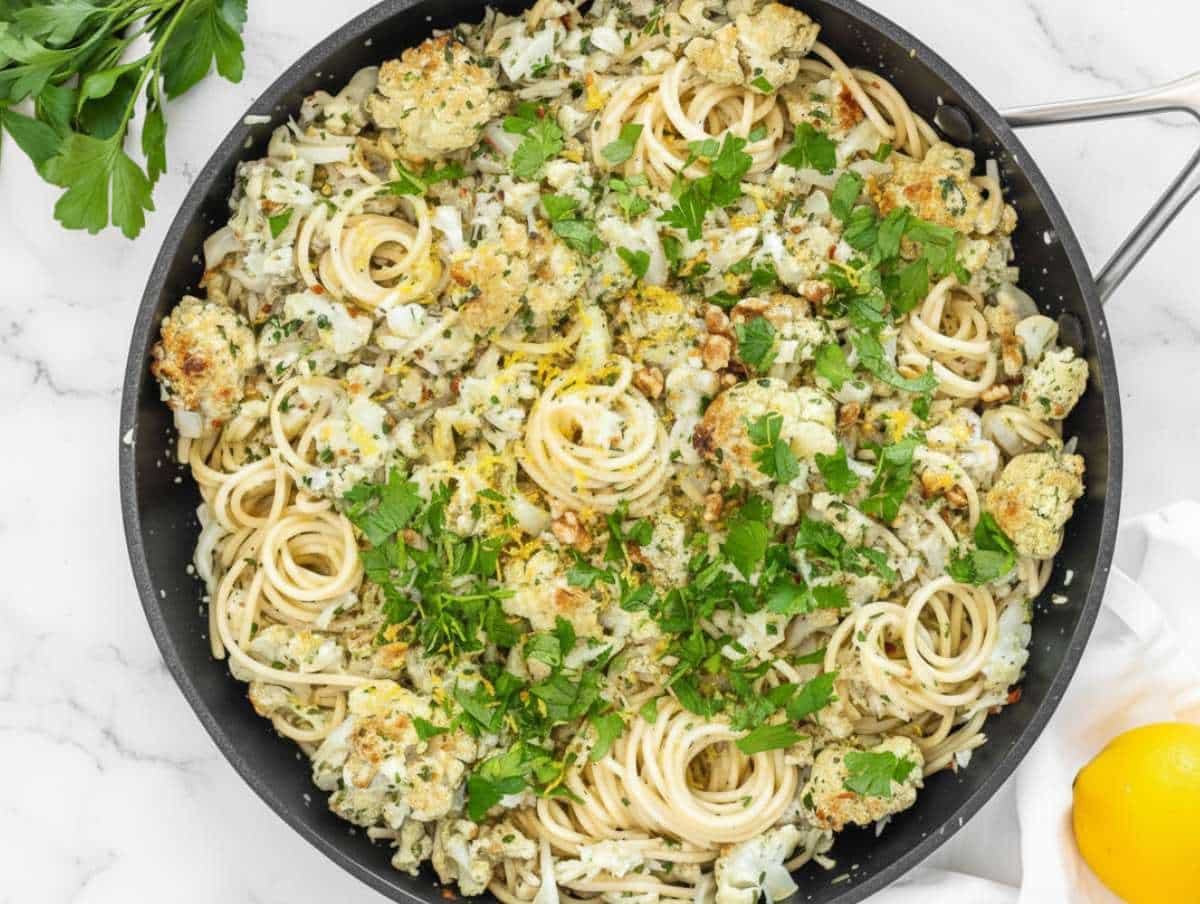 Step 4 Tossing spaghetti with cauliflower sauce parmesan and pasta water.