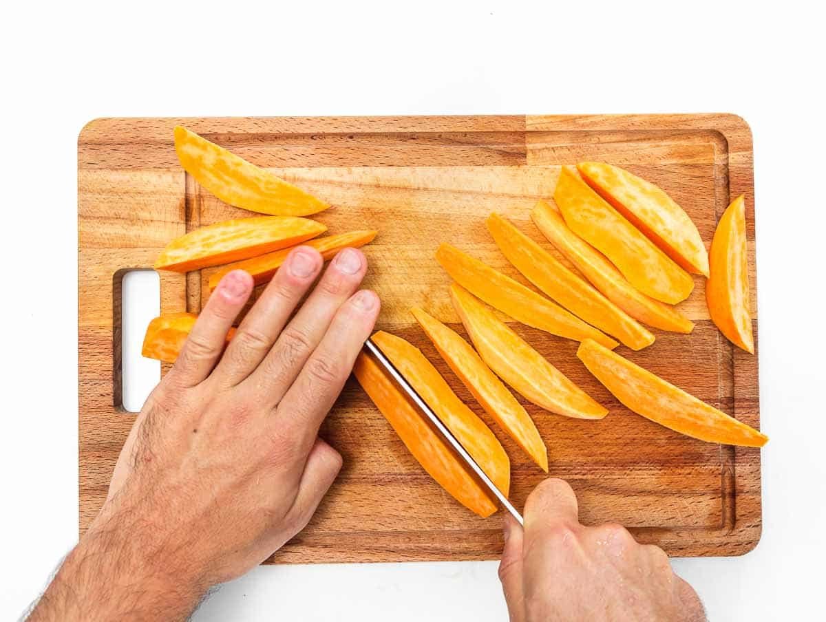 cutting the sweet potatoes into wedges