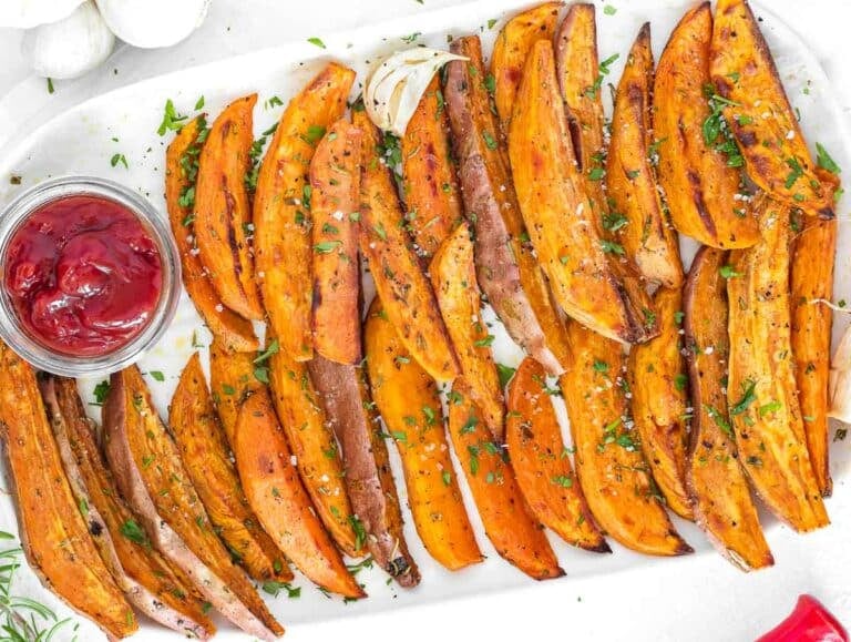 roasted sweet potato wedges on a platter with ketchup