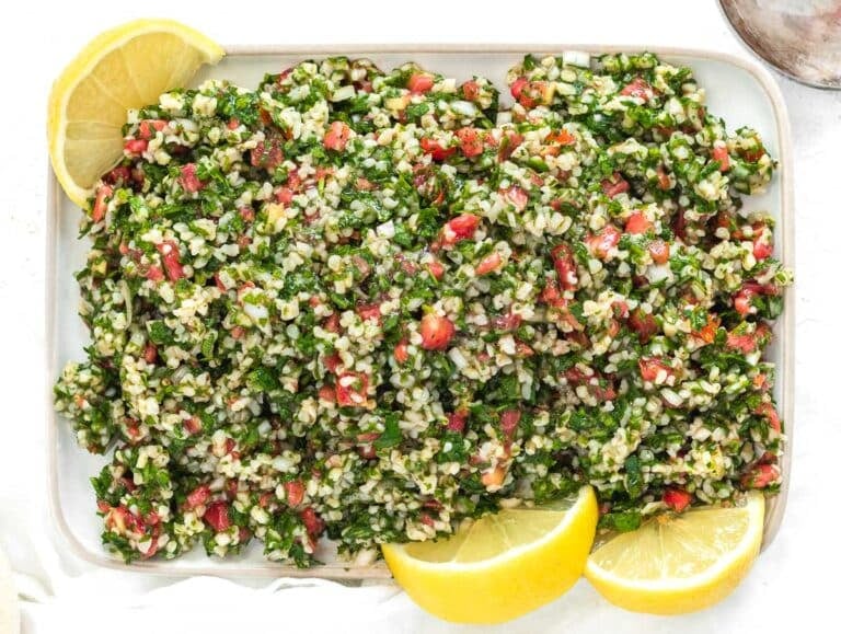 Tabouli recipe on a platter with lemon wedges