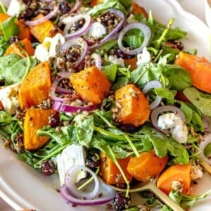 sweet potato salad with arugula and feta on a platter