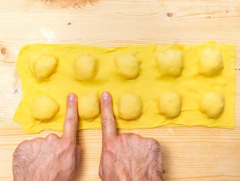 pushing out the air and sealing the ravioli