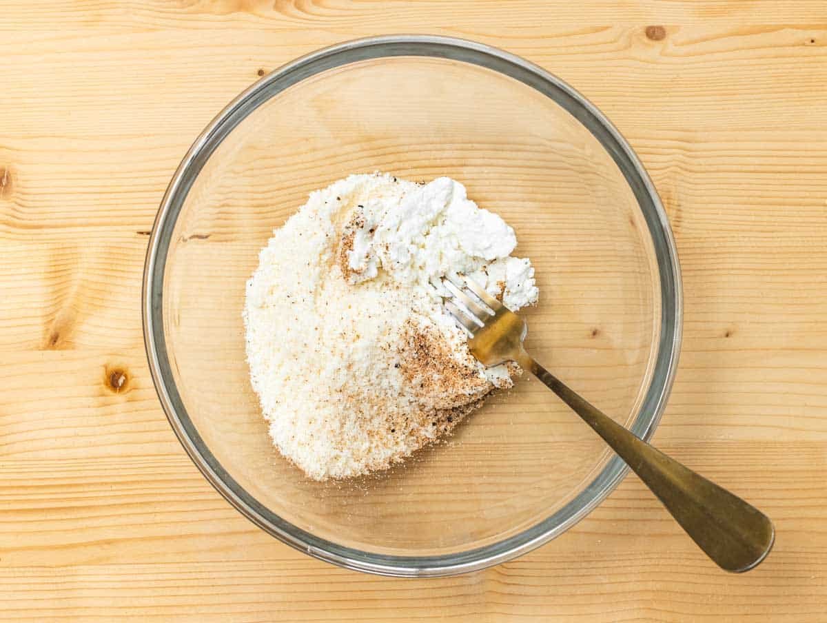 mixing ricotta with parmesan, salt, and nutmeg