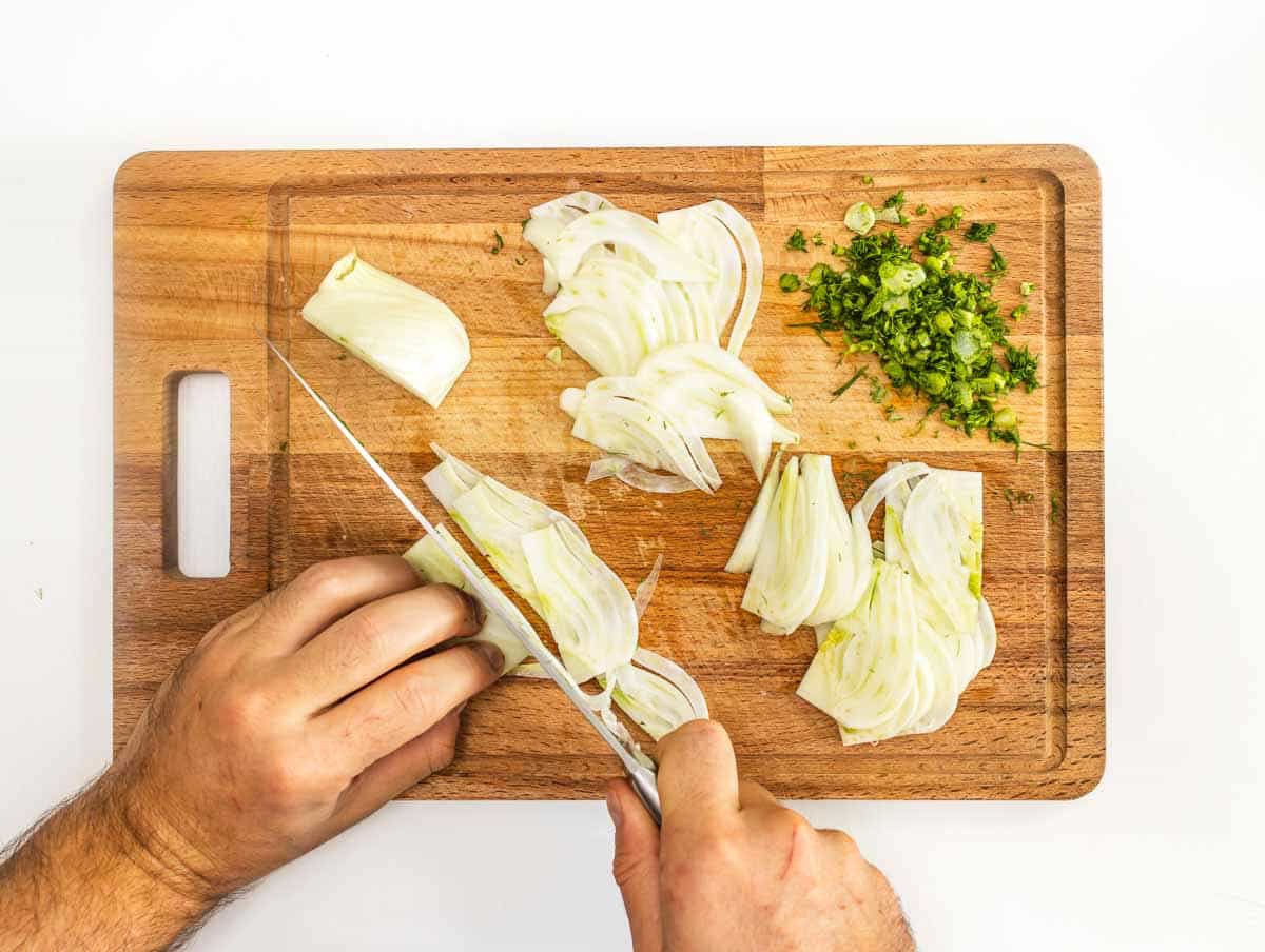 slicing the fennel on a cutting board