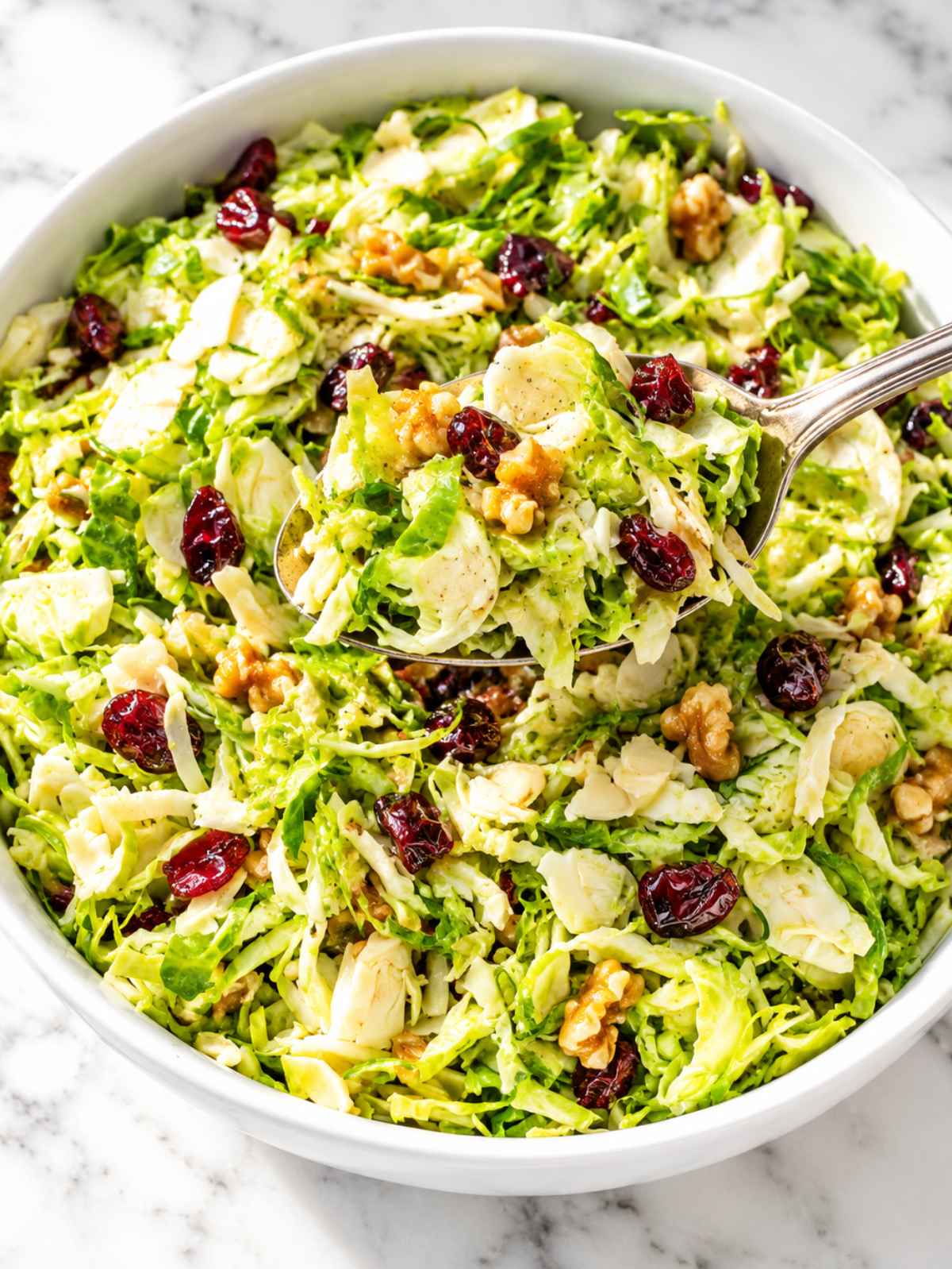 Shaved Brussels sprouts with cranberries and crunchy chopped walnuts.