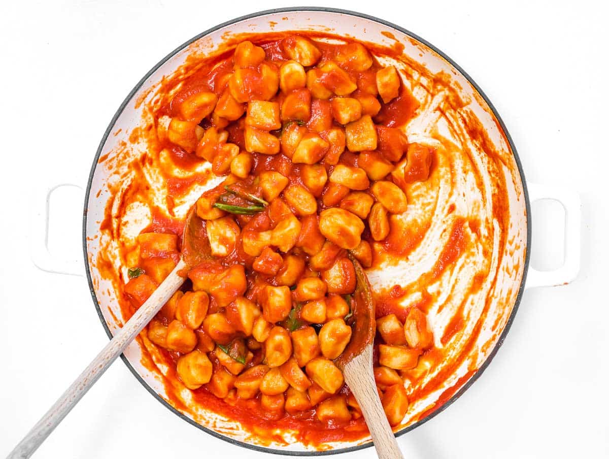 tossing the gnocchi in the sauce