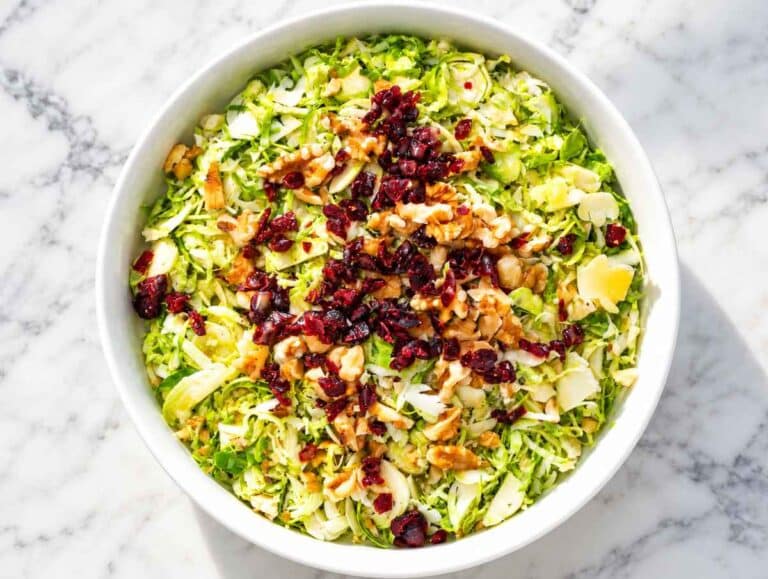 Step 2 Shaved Brussels sprouts topped with dried cranberries and chopped walnuts.
